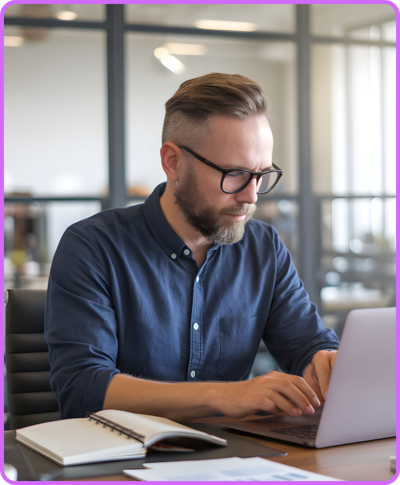 Bearded professional working on laptop
